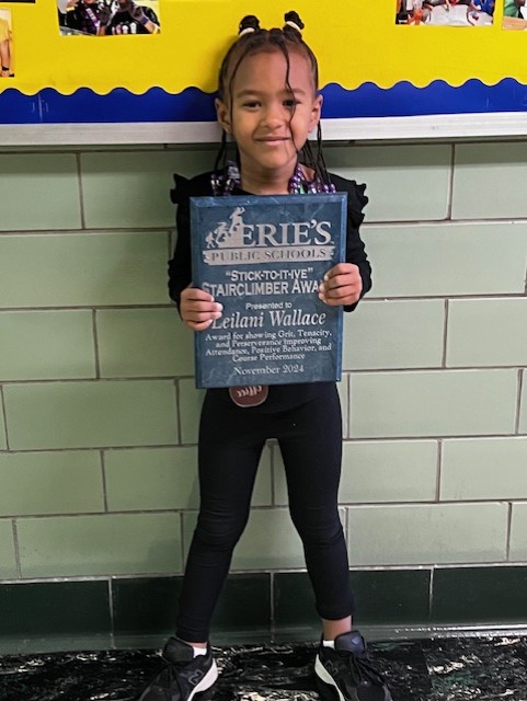 Leilani Wallace, Edison's Stairclimber for November, poses with her plaque.